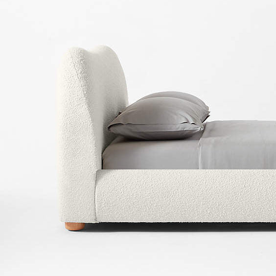 Modern bed with gray bedding on a white background