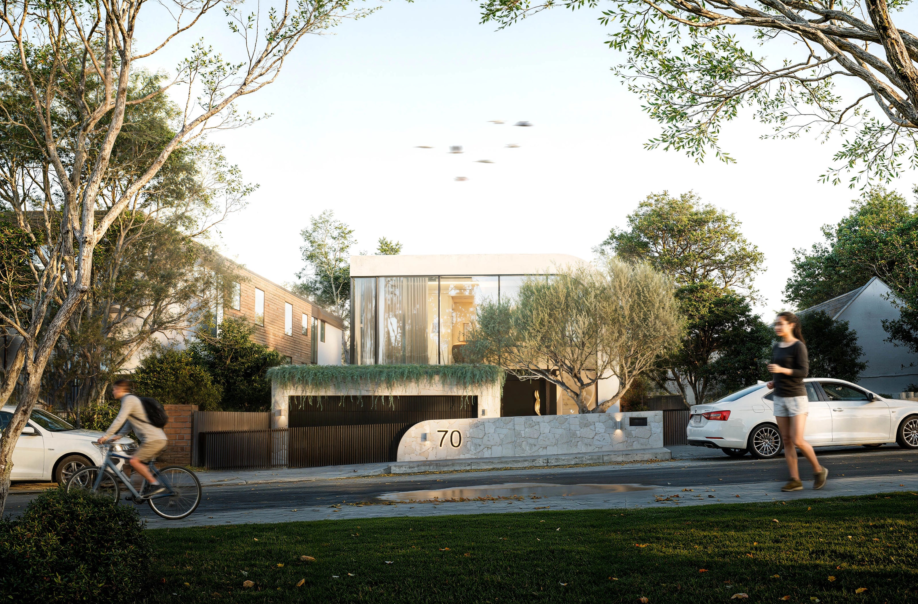Luxury modern home facade featuring curved glazing and stone frontage at 70 Cobden Melbourne by Albert Living.