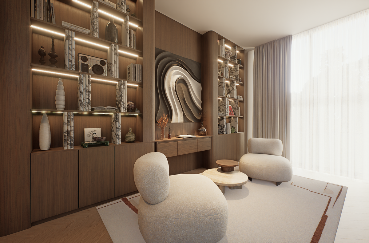 A modern living room interior with two rounded off-white lounge chairs on a light rug, built-in wood shelving with warm lighting and decor, and a large window with sheer curtains.